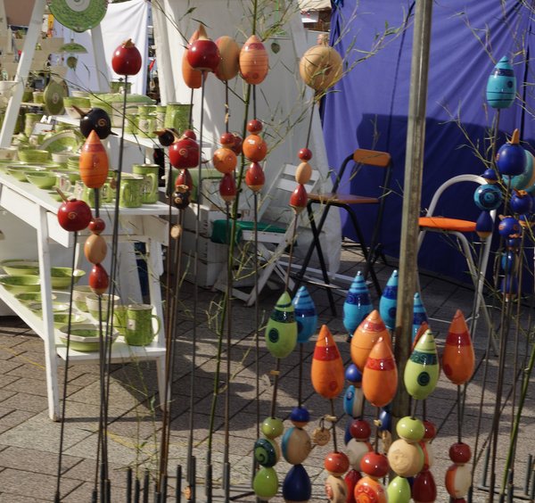 Verschiedene farbige Ornamente und Töpferwaren auf einem Marktstand